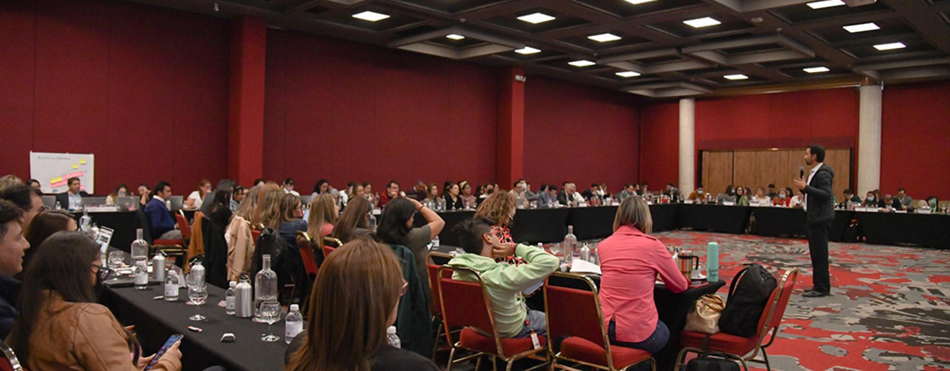 Sala del evento en donde se ven las personas reunidas.