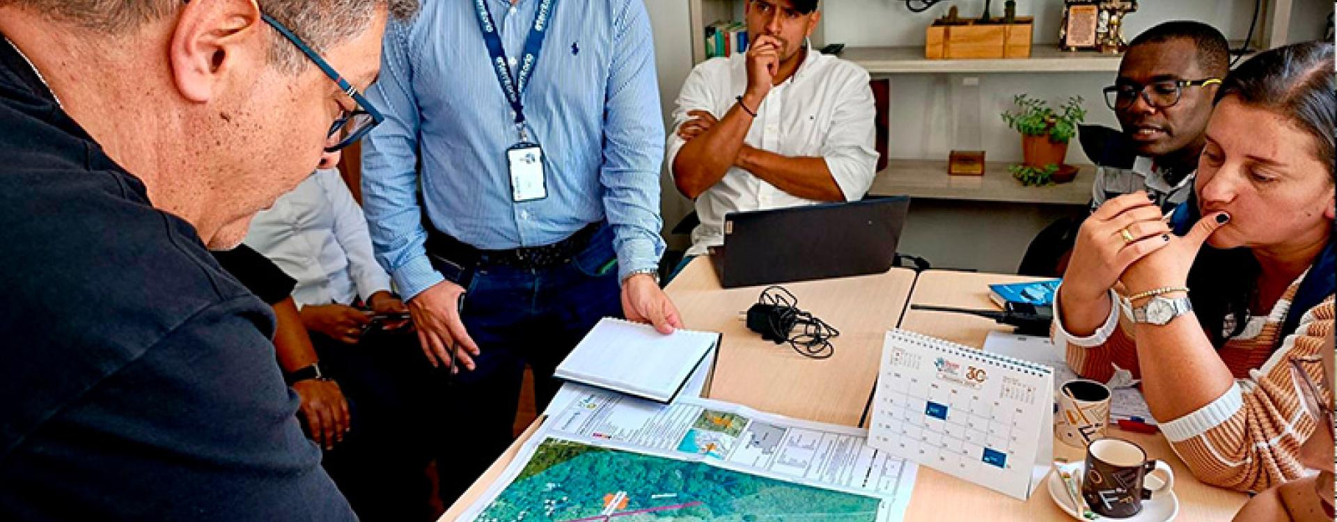 Personas reunidas observando un mapa.