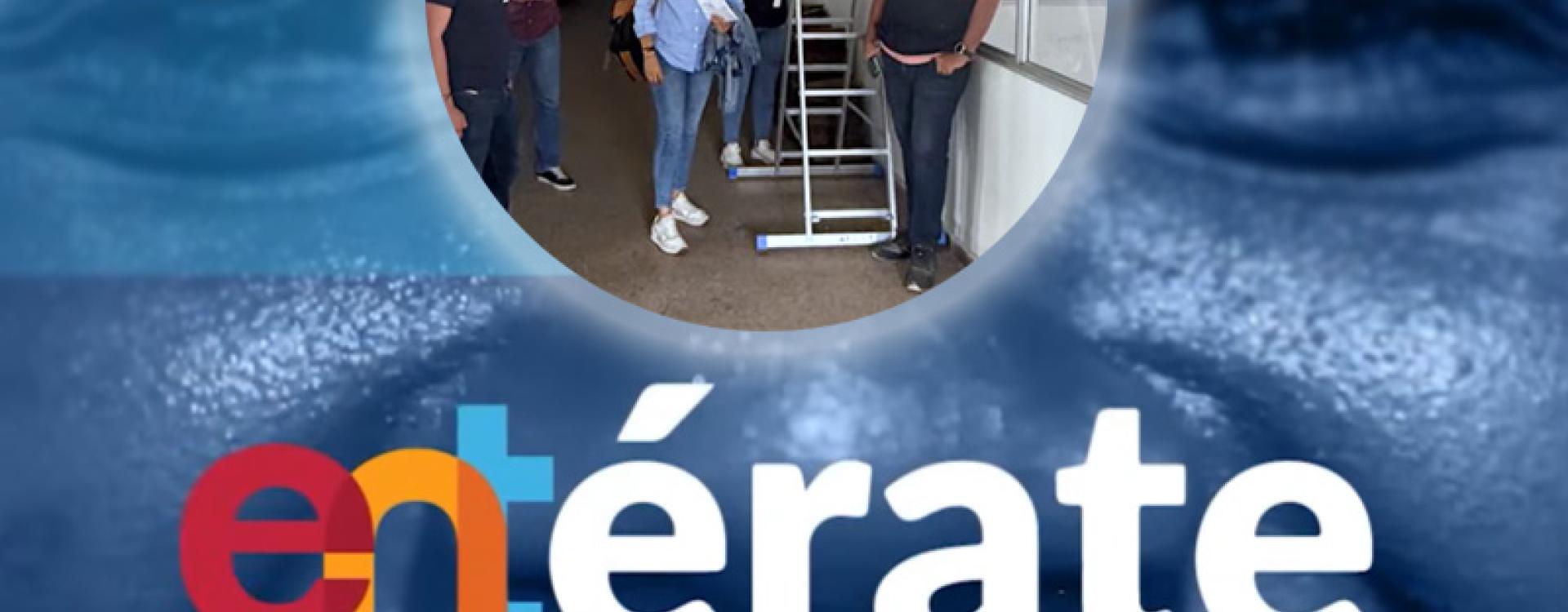 Foto de varias personas revisando una obra civil gris.